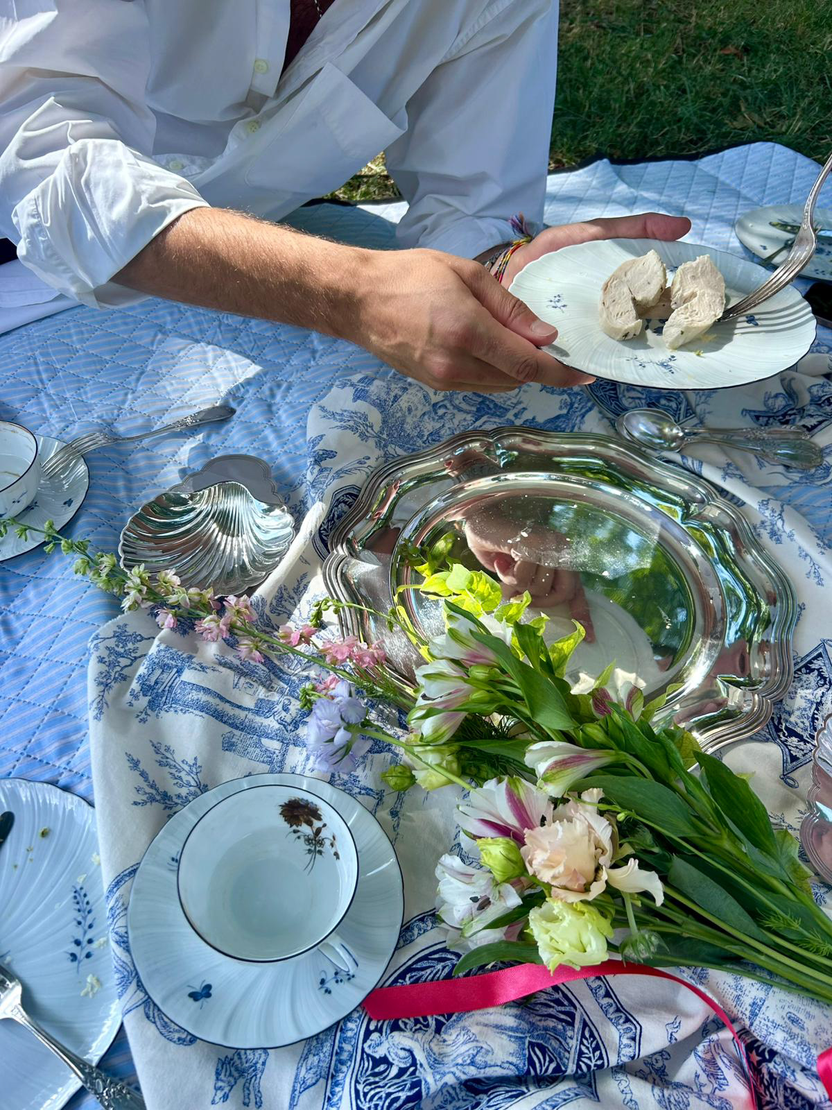 Marie Antoinette Luxury Picnic Setting. Flowers on silver platter and antique French porcelain.